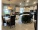 Modern kitchen with white cabinets, granite island, and breakfast bar at 2536 Marton Oak Blvd, North Port, FL 34289