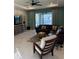 Living room features a sectional sofa and access to a patio with a lake view at 2536 Marton Oak Blvd, North Port, FL 34289