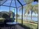 Relaxing screened porch overlooking a lake, perfect for outdoor dining at 2536 Marton Oak Blvd, North Port, FL 34289