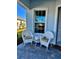 Front porch with white wicker chairs and side table at 25532 Royal Tern Ln, Englewood, FL 34223