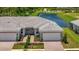 Two-unit home with attached garages and a pond view at 25917 Bimini Sands Ct, Englewood, FL 34223