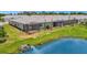 Rear view of two-unit home and community pond at 25917 Bimini Sands Ct, Englewood, FL 34223