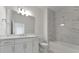 Bathroom with a bathtub, vanity, and marble tile at 25917 Bimini Sands Ct, Englewood, FL 34223