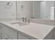 Bathroom vanity with quartz countertop and sink at 25917 Bimini Sands Ct, Englewood, FL 34223