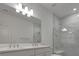 Bathroom with double vanity and marble shower at 25917 Bimini Sands Ct, Englewood, FL 34223