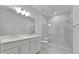 Modern bathroom with double vanity and a large shower at 25917 Bimini Sands Ct, Englewood, FL 34223