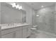 Modern bathroom with double vanity and a large shower at 25917 Bimini Sands Ct, Englewood, FL 34223