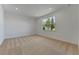 Spacious bedroom with carpet and a large window at 25917 Bimini Sands Ct, Englewood, FL 34223