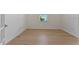 Empty bedroom with hardwood floors and a window with natural light at 25917 Bimini Sands Ct, Englewood, FL 34223