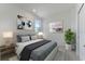 Bright bedroom with a queen-size bed and modern decor at 25917 Bimini Sands Ct, Englewood, FL 34223