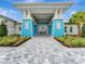 Attractive clubhouse entrance with a walkway and landscaping at 25917 Bimini Sands Ct, Englewood, FL 34223