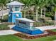 Beachwalk community entrance with a water feature and lush landscaping at 25917 Bimini Sands Ct, Englewood, FL 34223