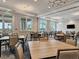 Bright community room with tables and chairs at 25917 Bimini Sands Ct, Englewood, FL 34223