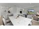 Bright dining area with a marble top table and modern chairs near the kitchen at 25917 Bimini Sands Ct, Englewood, FL 34223