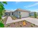 Front view of home with attached garage and landscaping at 25917 Bimini Sands Ct, Englewood, FL 34223