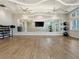 Fitness studio with large mirror, hardwood floors, and equipment at 25917 Bimini Sands Ct, Englewood, FL 34223