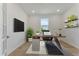 Spacious home office, featuring built-in shelving and wood floors at 25917 Bimini Sands Ct, Englewood, FL 34223