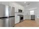 Modern kitchen with stainless steel appliances and white shaker cabinets at 25917 Bimini Sands Ct, Englewood, FL 34223