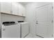 Laundry room with washer, dryer, and cabinets at 25917 Bimini Sands Ct, Englewood, FL 34223
