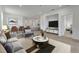 Open concept living room features hardwood floors and modern furnishings at 25917 Bimini Sands Ct, Englewood, FL 34223