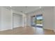 Living room with sliding glass doors opening to a backyard patio at 25917 Bimini Sands Ct, Englewood, FL 34223