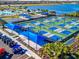 Expansive pickleball courts with many players enjoying a sunny day at 25917 Bimini Sands Ct, Englewood, FL 34223