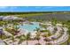 Aerial view of resort pool with expansive deck and lake view at 25917 Bimini Sands Ct, Englewood, FL 34223