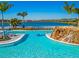Stunning resort-style pool with a waterfall and lake view at 25917 Bimini Sands Ct, Englewood, FL 34223