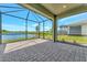 Screened porch overlooking pond and backyard at 25917 Bimini Sands Ct, Englewood, FL 34223