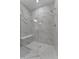 Large walk-in shower with marble tile and built-in seat at 25917 Bimini Sands Ct, Englewood, FL 34223