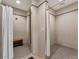 Clean showers with privacy curtains and bench at 25917 Bimini Sands Ct, Englewood, FL 34223