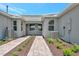 Side yard view of home with pavers and landscaping at 25917 Bimini Sands Ct, Englewood, FL 34223