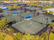 Aerial view of community tennis courts with players at 25917 Bimini Sands Ct, Englewood, FL 34223