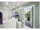 Bathroom with white vanity, toilet and access to the patio at 2905 Seasons Blvd, Sarasota, FL 34240