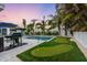 Tropical backyard oasis with pool, putting green, and patio at 306 66Th St, Holmes Beach, FL 34217