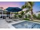 Poolside lounge chairs under an umbrella near the pool at 306 66Th St, Holmes Beach, FL 34217