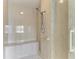 Walk-in shower with tiled walls and safety features at 306 Golden Gate Pt # 2, Sarasota, FL 34236