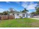 Single story home with a grassy yard and wooden fence at 3634 Lokai Pl, Sarasota, FL 34232