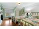 Bedroom featuring twin beds with bright, patterned bedding and light green walls at 409 Pine Ave, Anna Maria, FL 34216