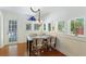 Bright dining room featuring hardwood floors, a unique light fixture, and plenty of natural light at 409 Pine Ave, Anna Maria, FL 34216