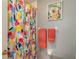 Bathroom with colorful shower curtain and floral wall art at 4228 Central Sarasota Pkwy # 1013, Sarasota, FL 34238