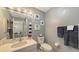Clean bathroom with white vanity, toilet, and striped shower curtain at 4228 Central Sarasota Pkwy # 1013, Sarasota, FL 34238