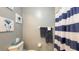 Simple bathroom with toilet, shower, and blue and white decor at 4228 Central Sarasota Pkwy # 1013, Sarasota, FL 34238