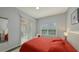 Bedroom with red bedding and access to a private balcony at 4228 Central Sarasota Pkwy # 1013, Sarasota, FL 34238