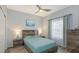 Guest bedroom with teal bedding and wood-toned furniture at 4228 Central Sarasota Pkwy # 1013, Sarasota, FL 34238
