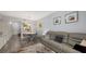 Open concept living and dining area with a round table and gray cushioned chairs at 4228 Central Sarasota Pkwy # 1013, Sarasota, FL 34238