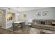 Modern dining area with a round table and gray chairs, open to the living room at 4228 Central Sarasota Pkwy # 1013, Sarasota, FL 34238