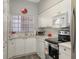 Well-equipped kitchen featuring stainless steel appliances and white cabinets at 4228 Central Sarasota Pkwy # 1013, Sarasota, FL 34238