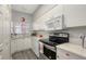 Updated kitchen with white cabinets, stainless steel appliances, and quartz countertops at 4228 Central Sarasota Pkwy # 1013, Sarasota, FL 34238