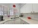 Modern kitchen features white cabinets, quartz countertops, and stainless steel appliances at 4228 Central Sarasota Pkwy # 1013, Sarasota, FL 34238